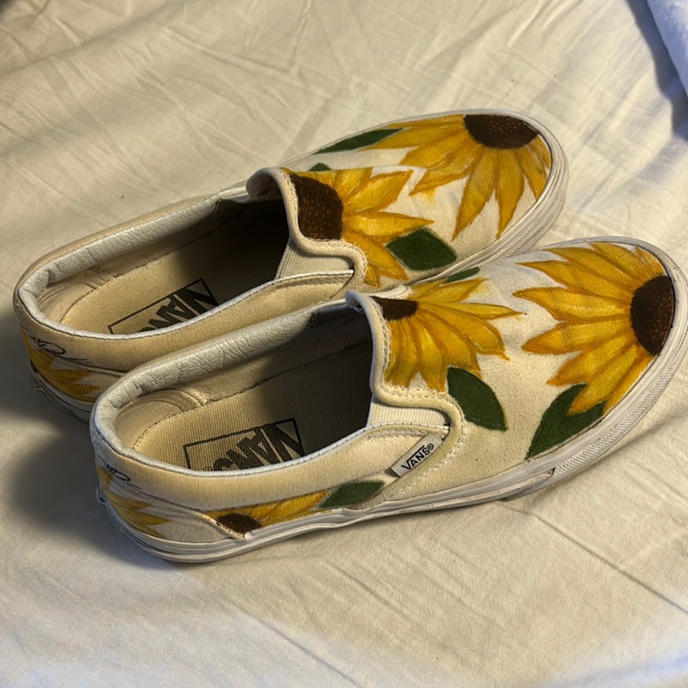 White vans with sunflowers painted on them